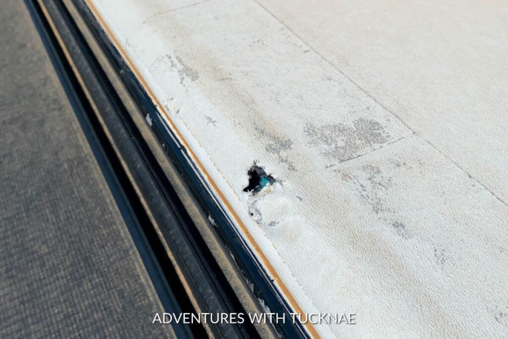 Picture showing the hole in our RV roof. The hole is just on the side of the roof and is the size of a small coin. 