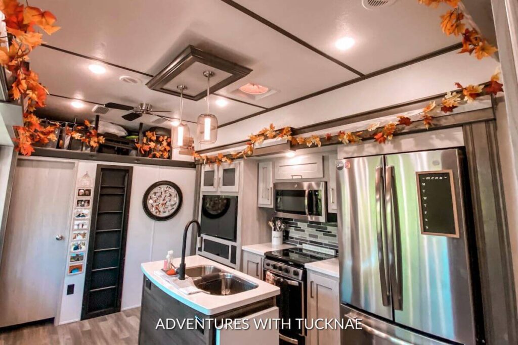 The view of our RV kitchen decorated for fall with fall leaves above the slides. 