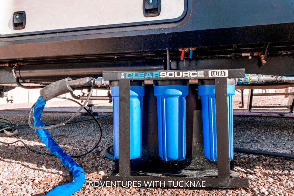 A clearsource ultra water filtration system being used as an RV boondocking essential in front of an RV.