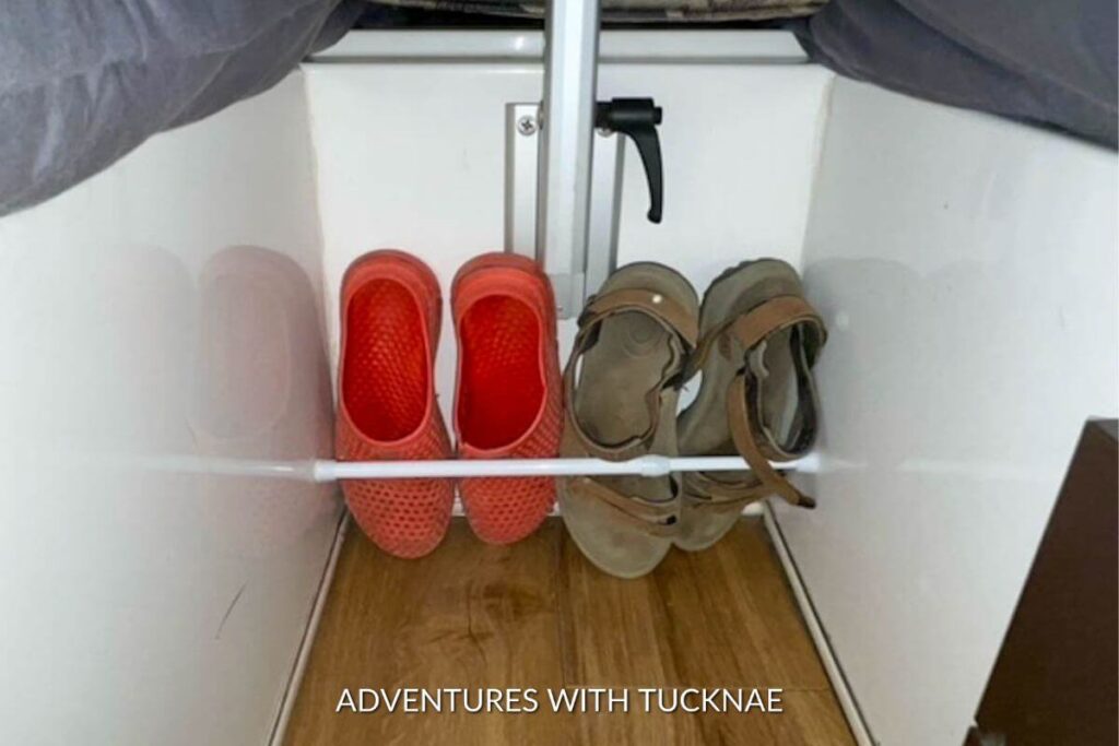 A Casita Independence RV showing a tension rod creating shoe storage