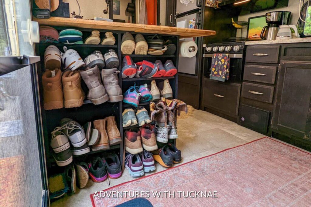 The entryway of a Grand Design Imagine XLS 18RBE RV showing a large shoe organizer full of shoes