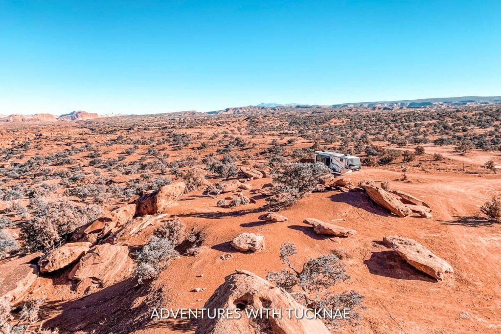 An RV boondocking amidst the rocky desert landscape of Southern Utah