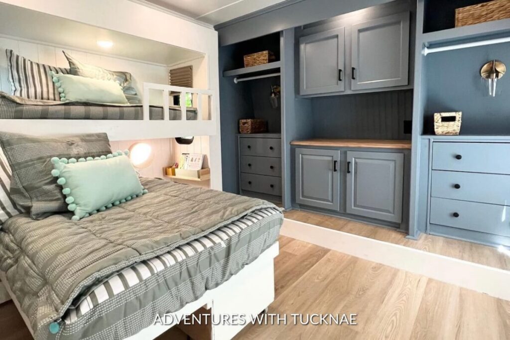 A sleek, modern RV bedroom remodel with green and deep blue accents