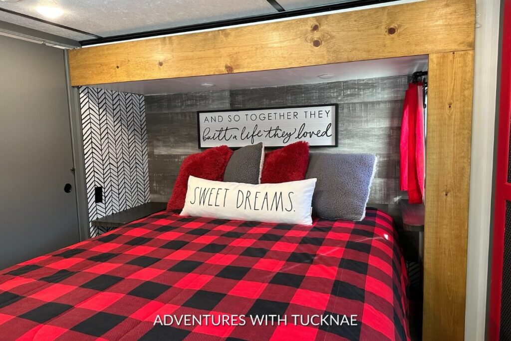 A modern RV bedroom makeover with black, white, and red accents