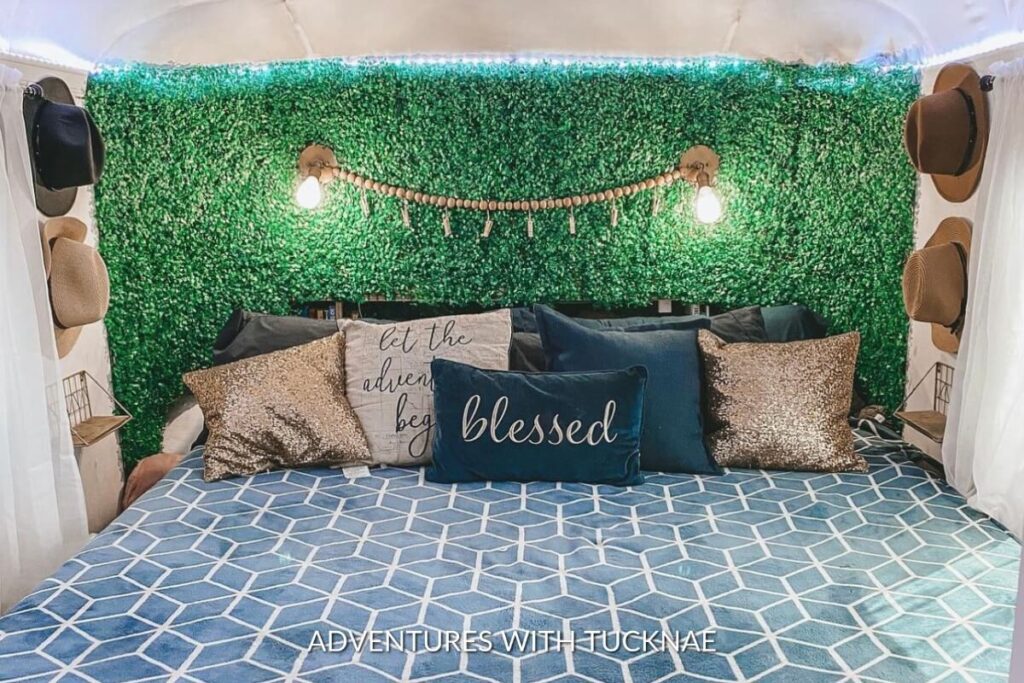 A colorful RV bedroom with green and blue decorations