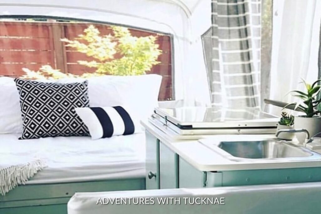 A cute RV renovation with black, white, and green accents