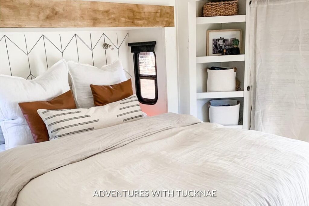A modern RV bedroom remodel with white and earth tones