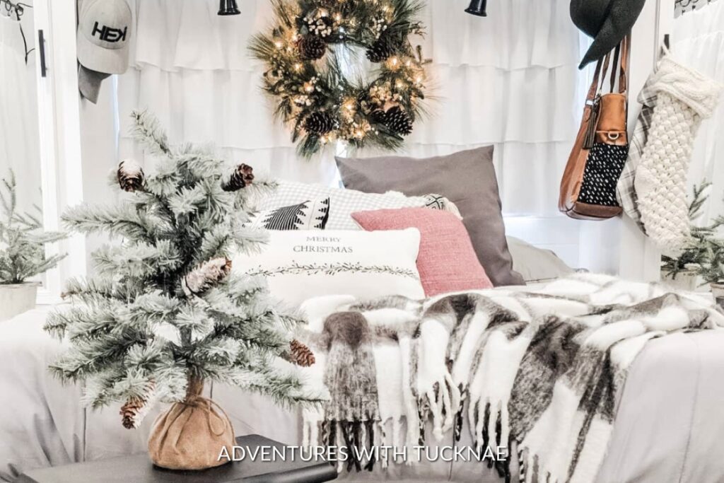 A cozy RV decorated for Christmas with a tiny tree