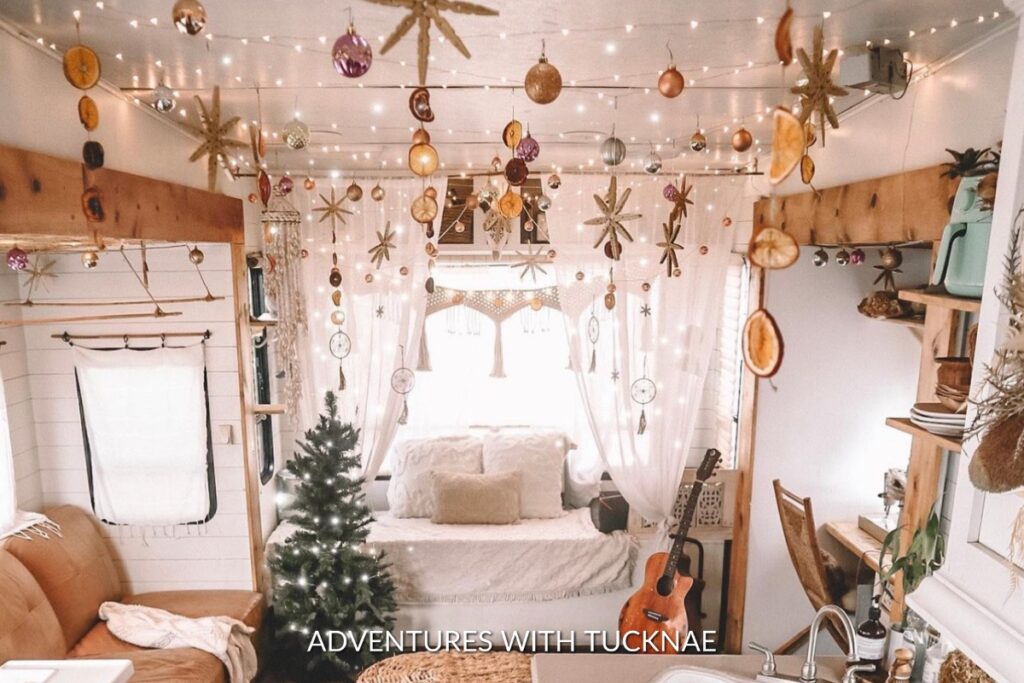 A festive RV decorated for Christmas with lights and ornaments hung from the ceiling