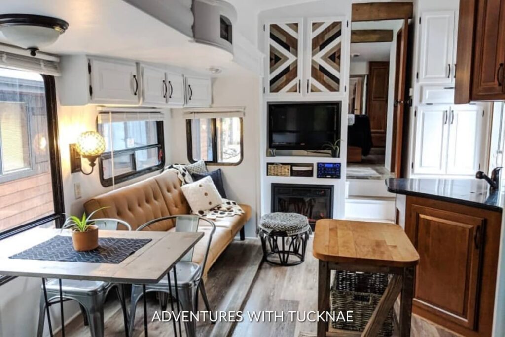 A neutrally renovated RV with white, black, and wood accents.