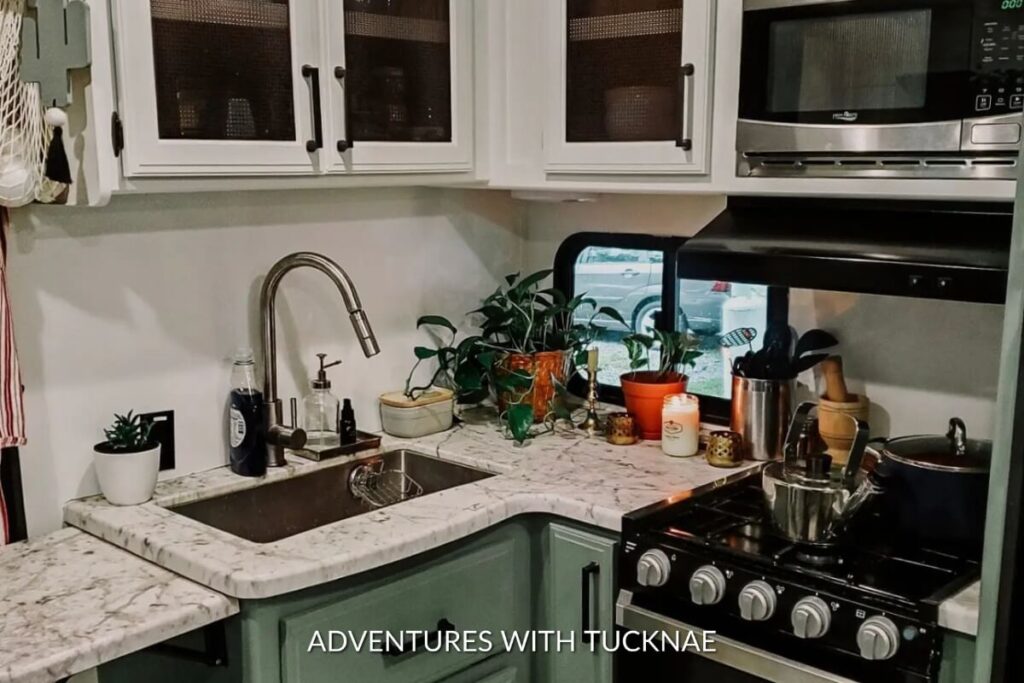 A painted RV kitchen with plants on the counters