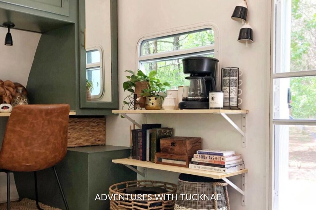 A green and white RV renovation with added shelves on the wall