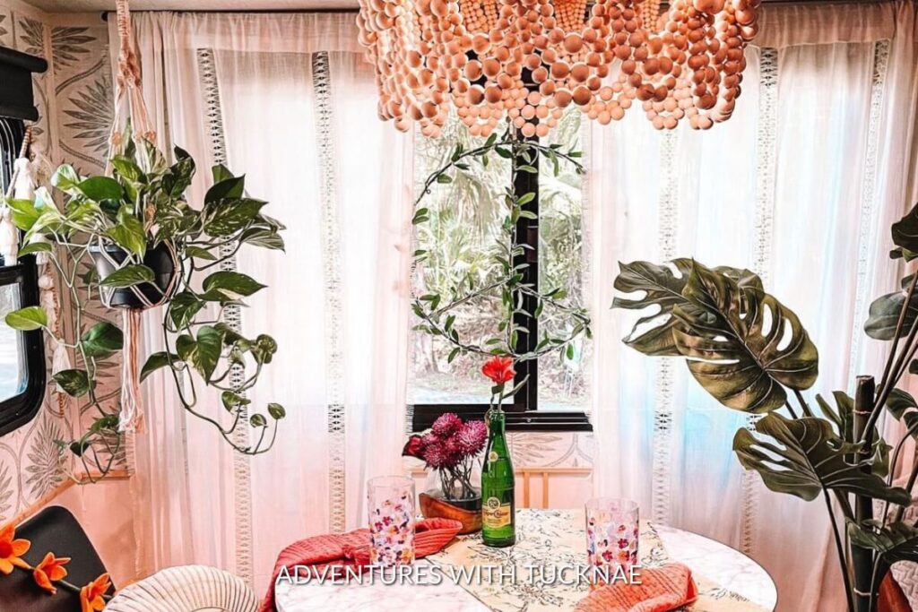 A stunning RV renovation with a custom chandelier and lots of plants
