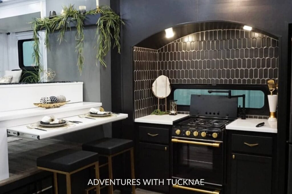 A dark and dramatic RV kitchen renovation that is black and white.