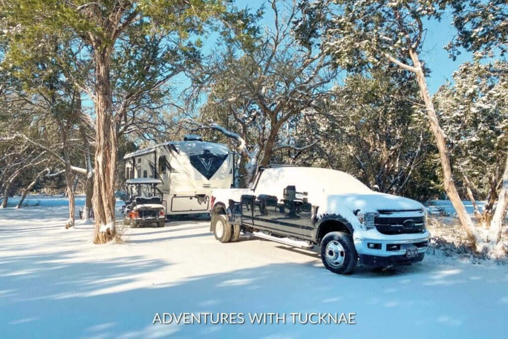 A Voltage fifth wheel RV and truck in the snow