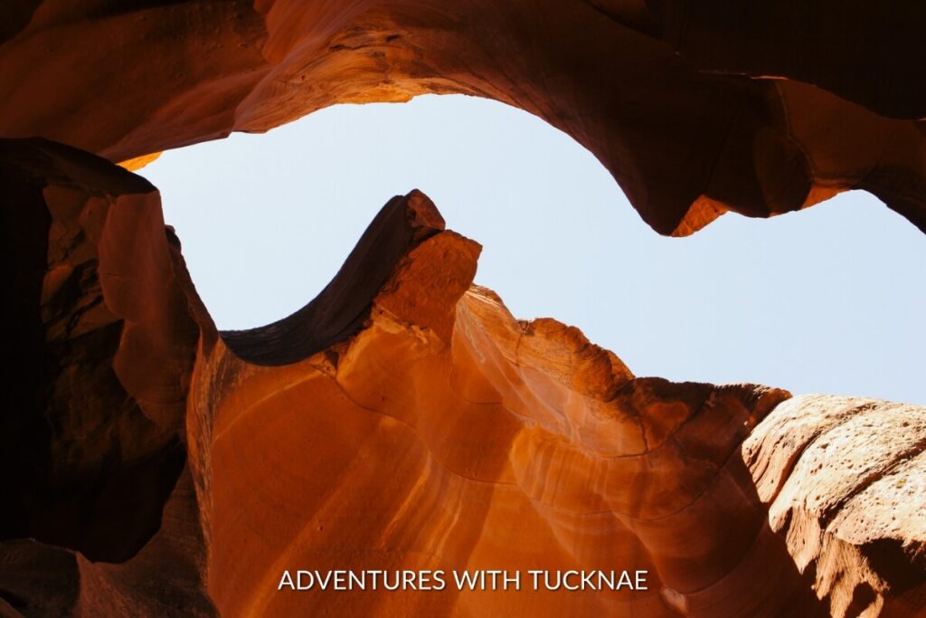 The iconic wave-like rock formations and warm hues of Upper Antelope Canyon, with sunlight creating a tranquil ambiance.