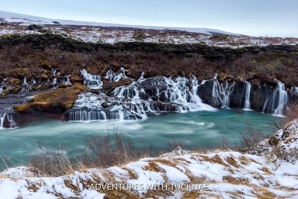Hraunfossar in Iceland, a stunning series of waterfalls flowing through lava fields, presenting a serene view of one of Iceland's best natural attractions.