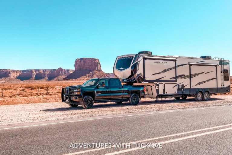 A fifth wheel RV and truck in Utah with a desert landscape behind them