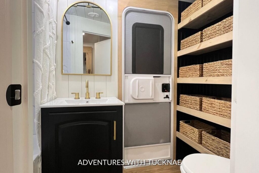 A neutral-colored RV bathroom renovation with lots of storage baskets
