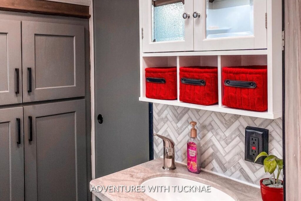 A red, grey, and white RV bathroom renovation