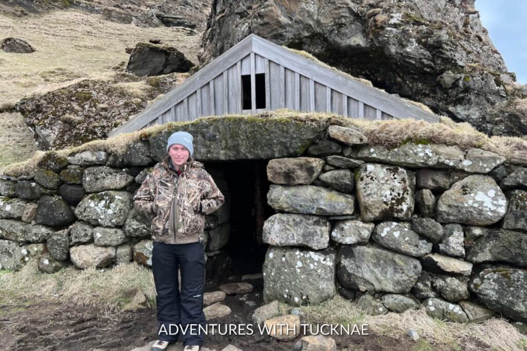 A man standing in front of the Rutshellir Caves near Vik Iceland