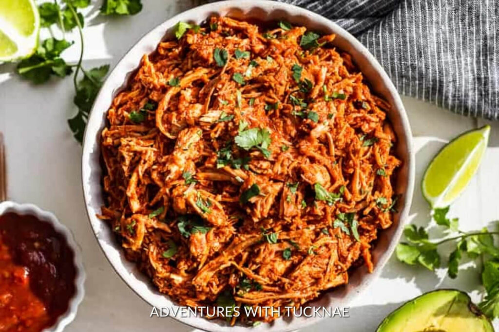 Spicy slow cooker chipotle chicken topped with fresh cilantro, a robust choice for RV camping crockpot meals.