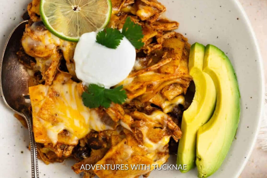 Delicious layers of crockpot chicken enchilada casserole with melted cheese, ideal for easy RV camping meals.
