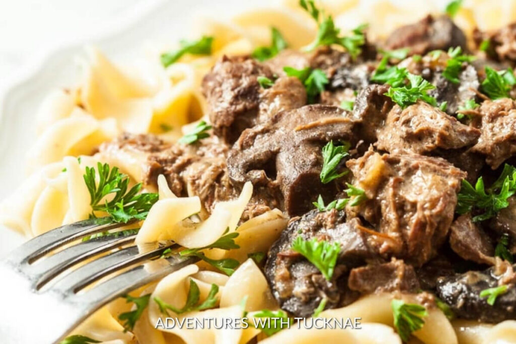 Creamy crockpot beef stroganoff served over noodles, a luxurious RV camping dinner option.