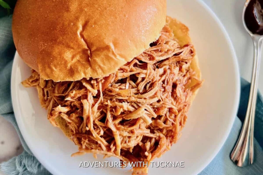 Slow cooker BBQ pulled chicken on a bun, a flavorful and convenient RV camping meal.