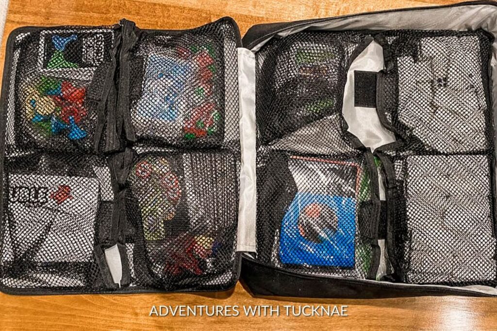 A travel-size board game organizer with colorful pieces visible through mesh pockets, highlighting organization accessories as useful gifts for RV owners.
