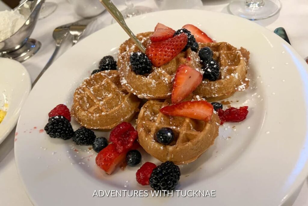 Delicious mini waffles topped with fresh strawberries, blackberries, and a dusting of powdered sugar, a sweet breakfast in Las Vegas.