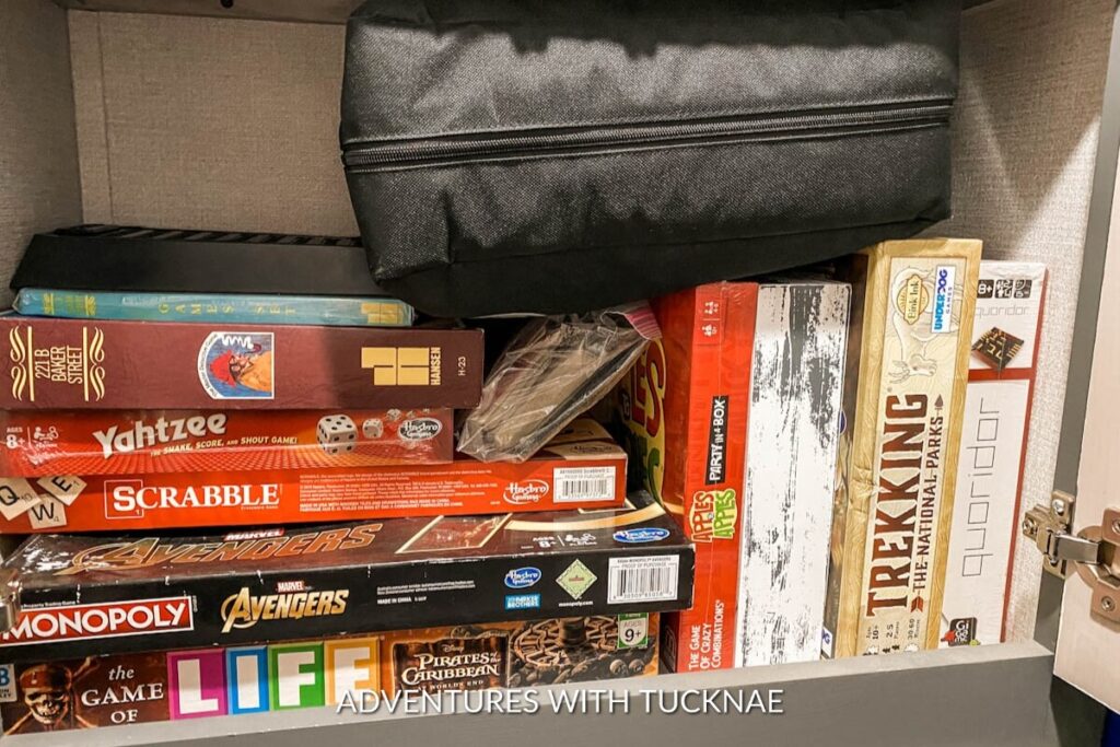 A cabinet full of games in an RV