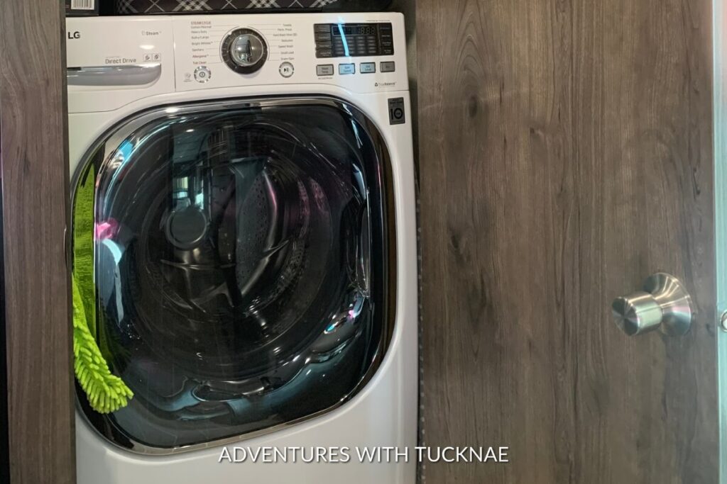 A modern white LG washing machine, set in an RV closet, demonstrating a practical RV laundry appliance.