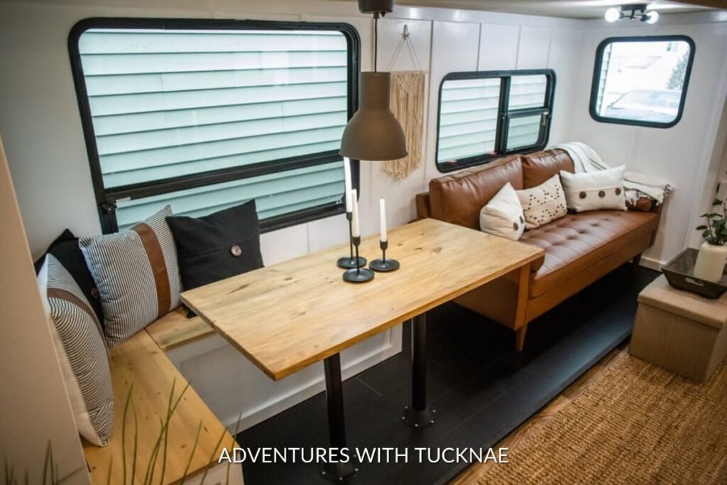 Cozy RV seating with a wooden table and black metal legs, a fusion of comfort and style for RV dining.