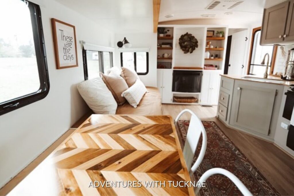Spacious RV featuring a wooden herringbone table with the phrase 'These are the days', a stylish and inspirational RV dining concept.