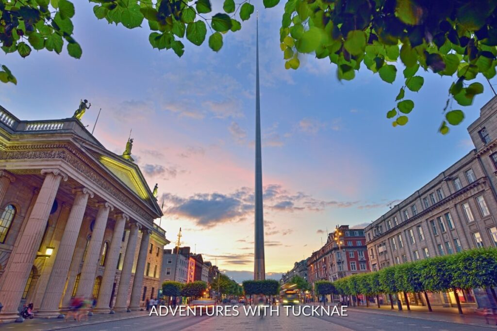 The Spire monument piercing the sky at dusk with street lights illuminating O’Connell Street, a landmark in Dublin.