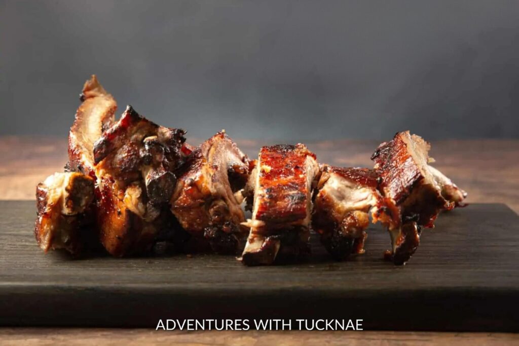 Instant Pot BBQ Ribs: Succulent Instant Pot BBQ ribs displayed on a wooden board, with a smoky glaze, ready to be enjoyed at a campsite.