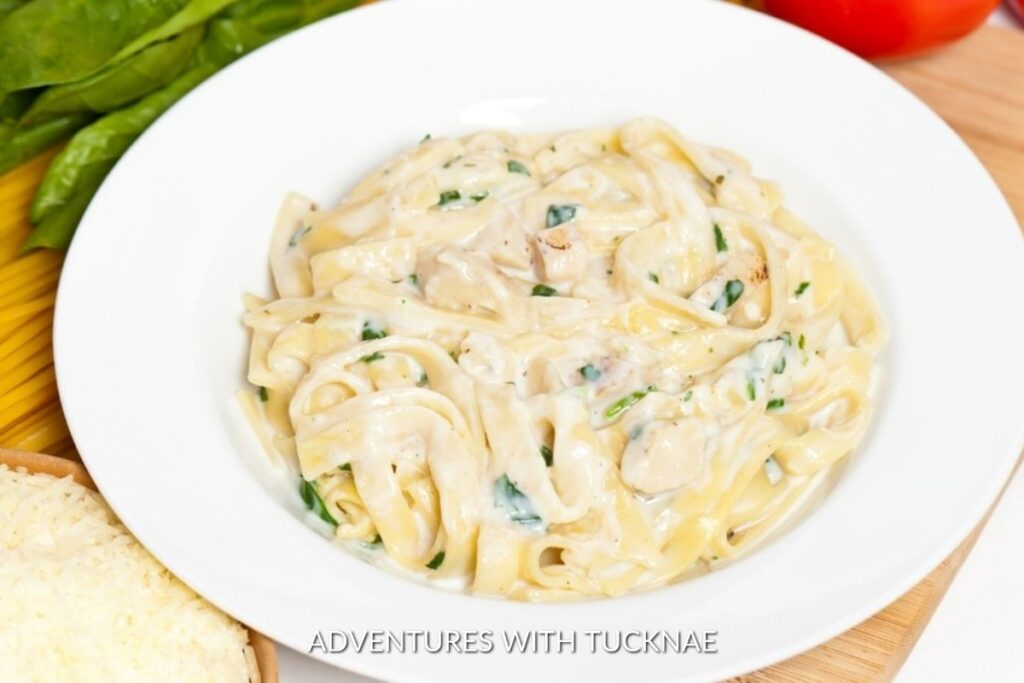 Instant Pot Fettuccine Alfredo: Classic Instant Pot fettuccine alfredo served on a white plate, creamy and garnished with parsley, a comforting campsite meal.