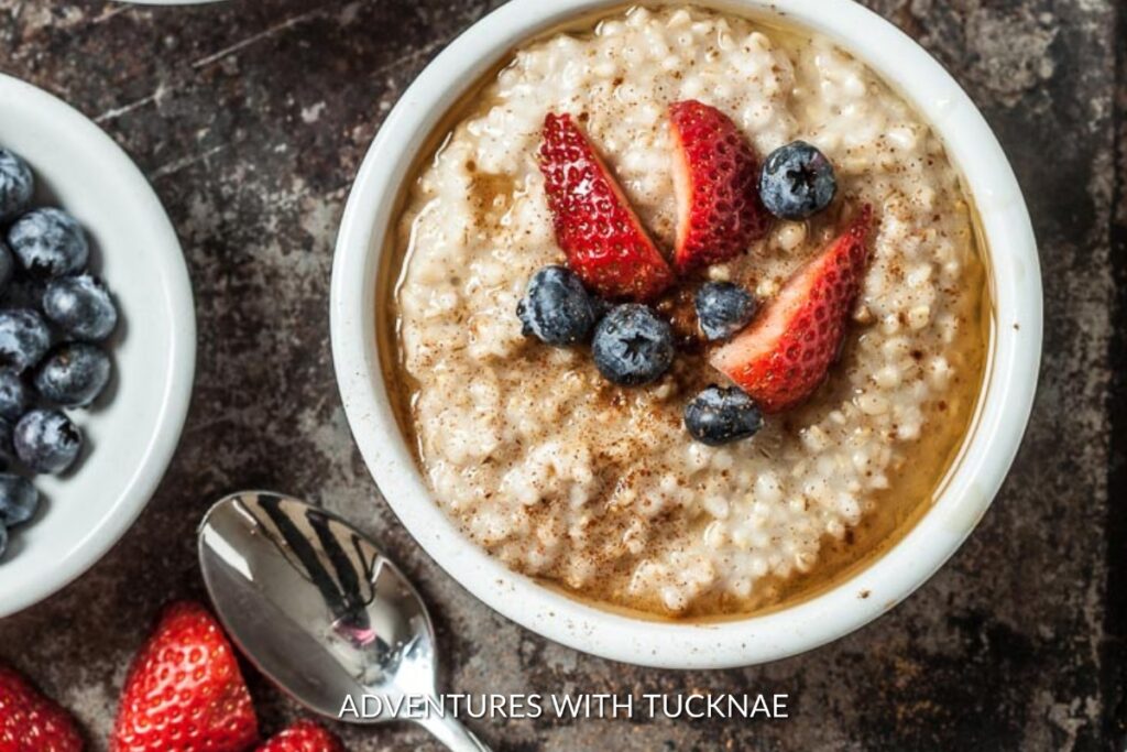 Instant Pot Steel Cut Oatmeal: A bowl of Instant Pot steel cut oatmeal topped with strawberries, blueberries, and a drizzle of honey, perfect for a nutritious camping breakfast.