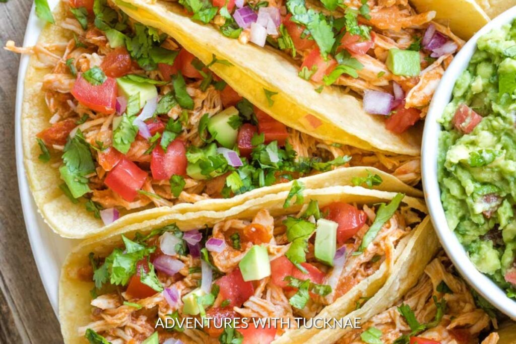 Instant Pot Chicken Tacos: Vibrant Instant Pot chicken tacos filled with shredded chicken, fresh tomatoes, cilantro, and avocado, a zesty and quick camping meal.