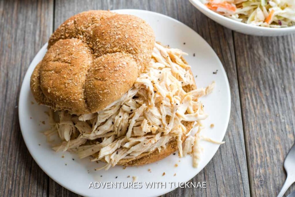 Instant Pot BBQ Chicken Sandwiches: Hearty Instant Pot BBQ chicken sandwiches piled on a whole wheat bun, a simple and delicious handheld meal for outdoor adventures.