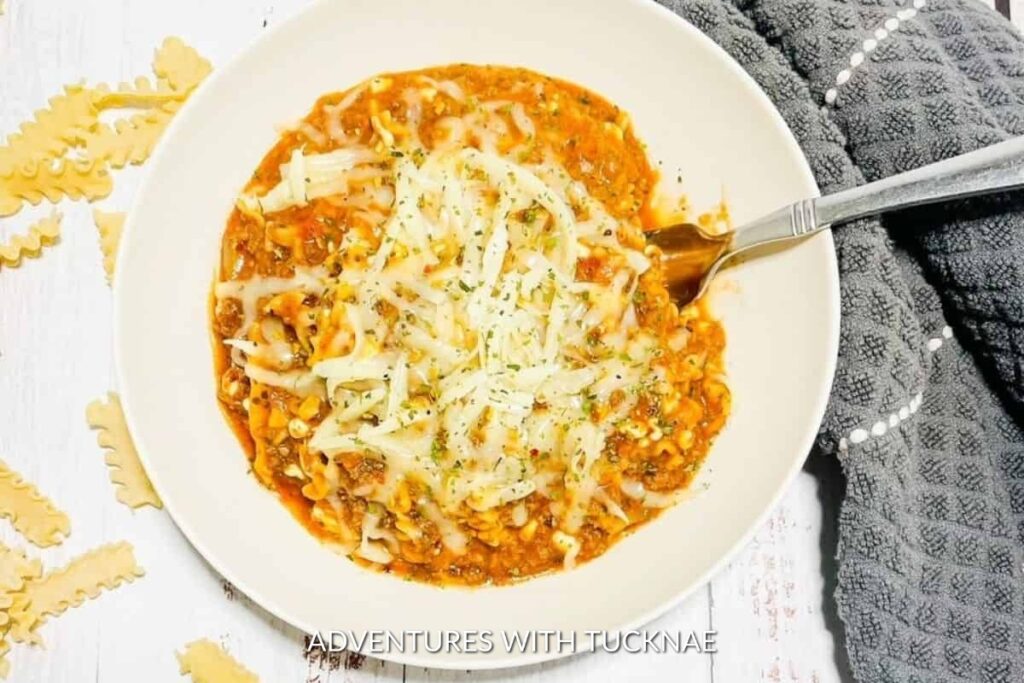 Instant Pot Lasagna: Homestyle Instant Pot lasagna in a bowl, layered with pasta, meat sauce, and melted cheese, a comforting one-pot meal for camping.