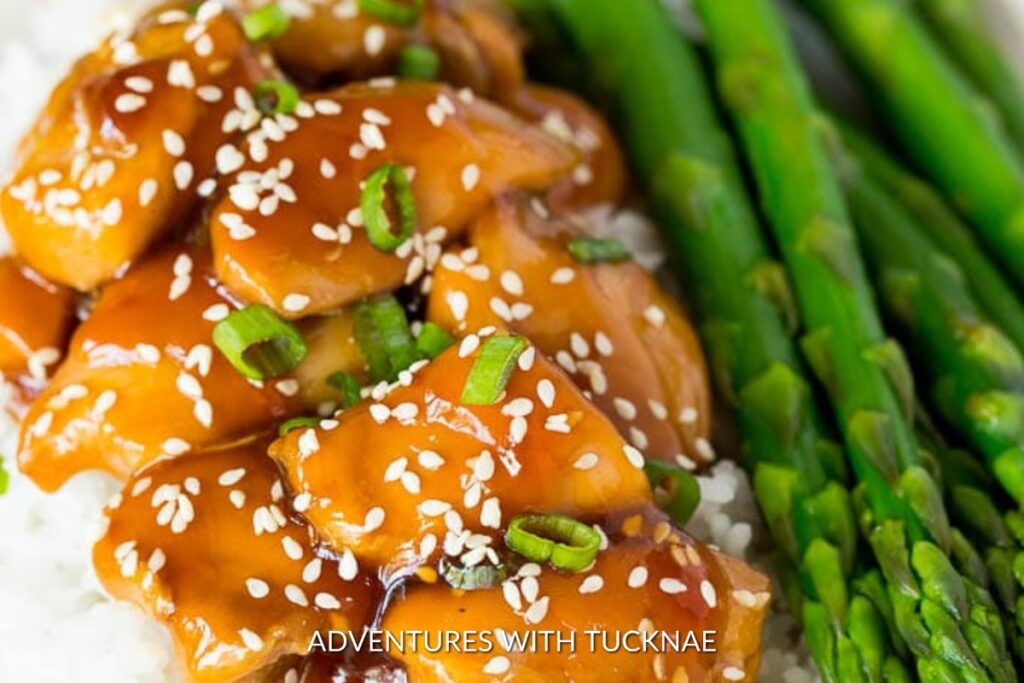 Juicy Instant Pot Teriyaki Chicken served with a side of bright green asparagus, a delightful Asian-inspired camping meal.