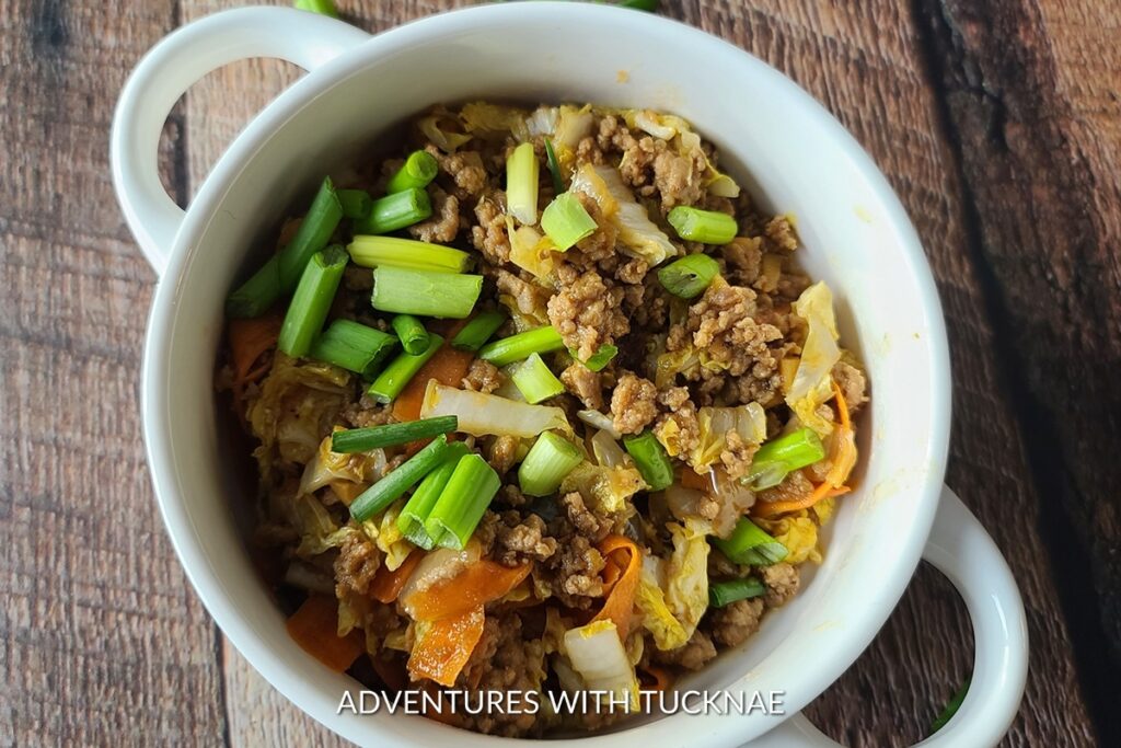 Deconstructed Instant Pot Egg Roll in a Bowl, with seasoned ground meat and vegetables, an innovative and easy camping meal.