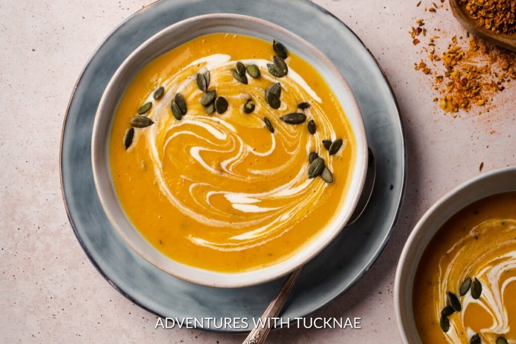 A smooth and velvety Instant Pot Butternut Squash Soup, garnished with cream and pumpkin seeds, a warming meal for chilly camping nights.