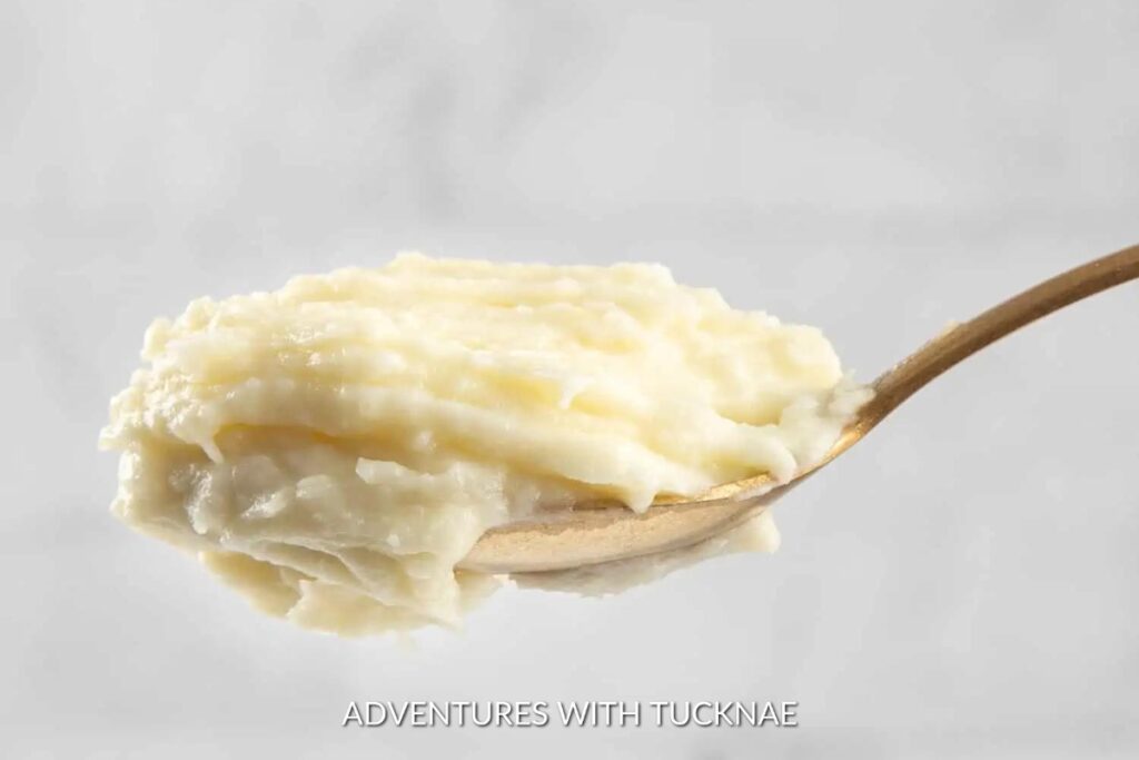 Instant Pot Mashed Potatoes: A wooden spoon scooping creamy Instant Pot mashed potatoes, a versatile side for any camping feast.