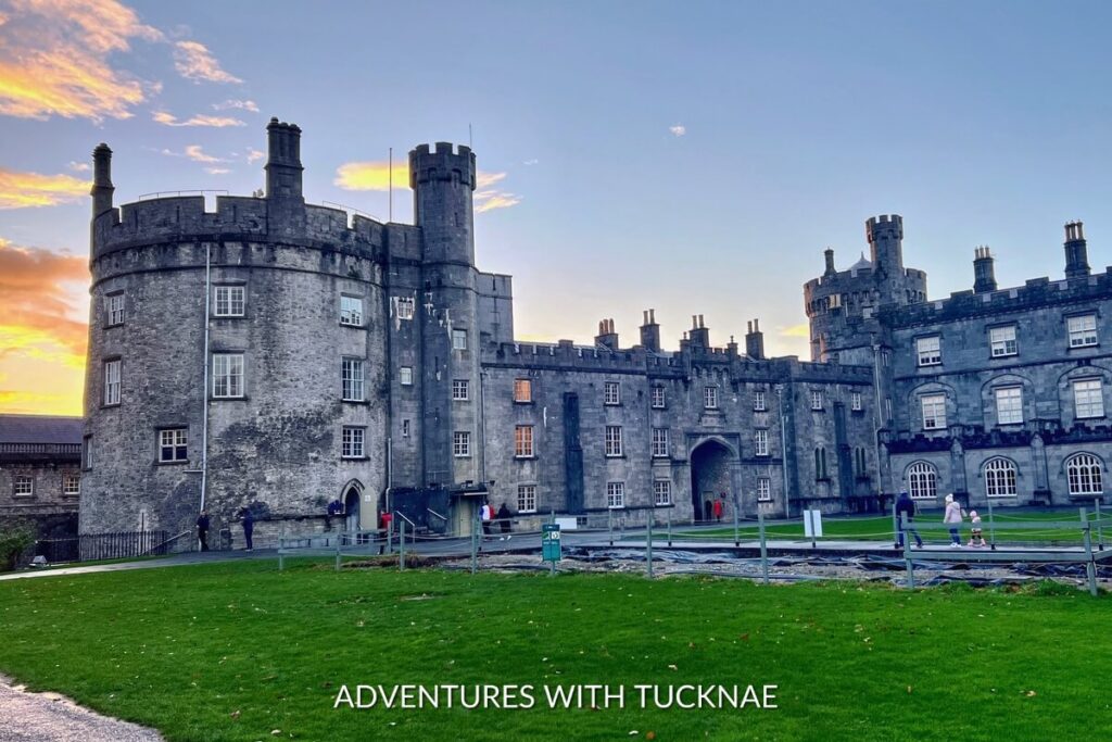 Sunset hues cast a warm glow over Kilkenny Castle, an iconic Instagram spot in Ireland, blending rich history with picturesque landscapes.