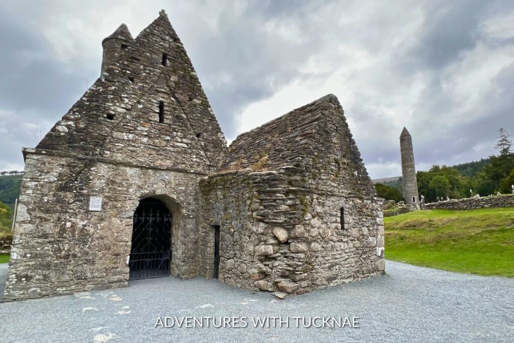 The ancient ruins of Glendalough, with a round tower standing tall amidst a graveyard, showcase the rich history of this Instagrammable place in Ireland.