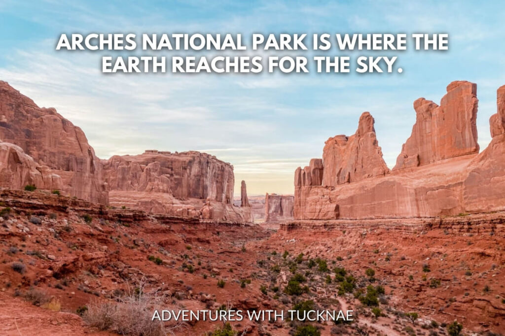 Towering sandstone fins and arches of Arches National Park against a clear sky, accompanied by the quote, "Arches National Park is where the earth reaches for the sky."