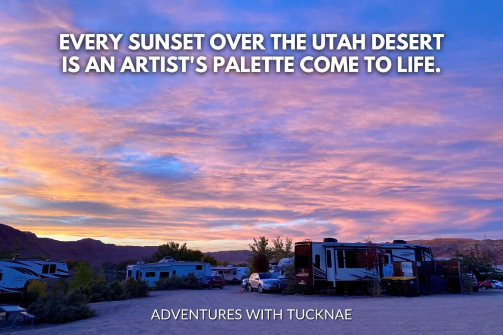 A vibrant sunset painting the clouds in shades of pink and purple over an RV campground in the Utah desert, illustrating the quote, "Every sunset over the Utah desert is an artist's palette come to life."